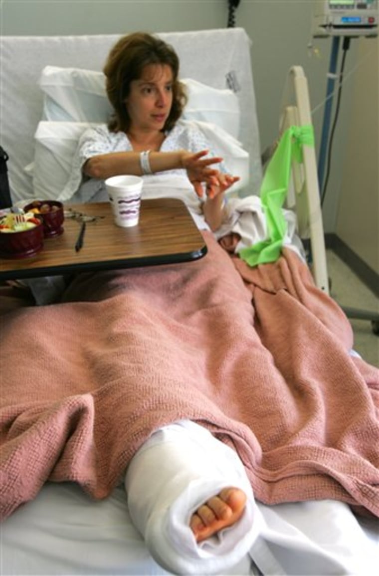 In this photo taken Aug. 30, 2004, Deborah Salamone, of Longwood, Fla., lays in hospital bed at Bert Fish Medical Center in New Smyrna Beach, Fla., after being bit on the right foot by a shark at Canaveral National Seashore the day before. (AP Photo/The Daytona Beach News-Journal, Roger Simms)